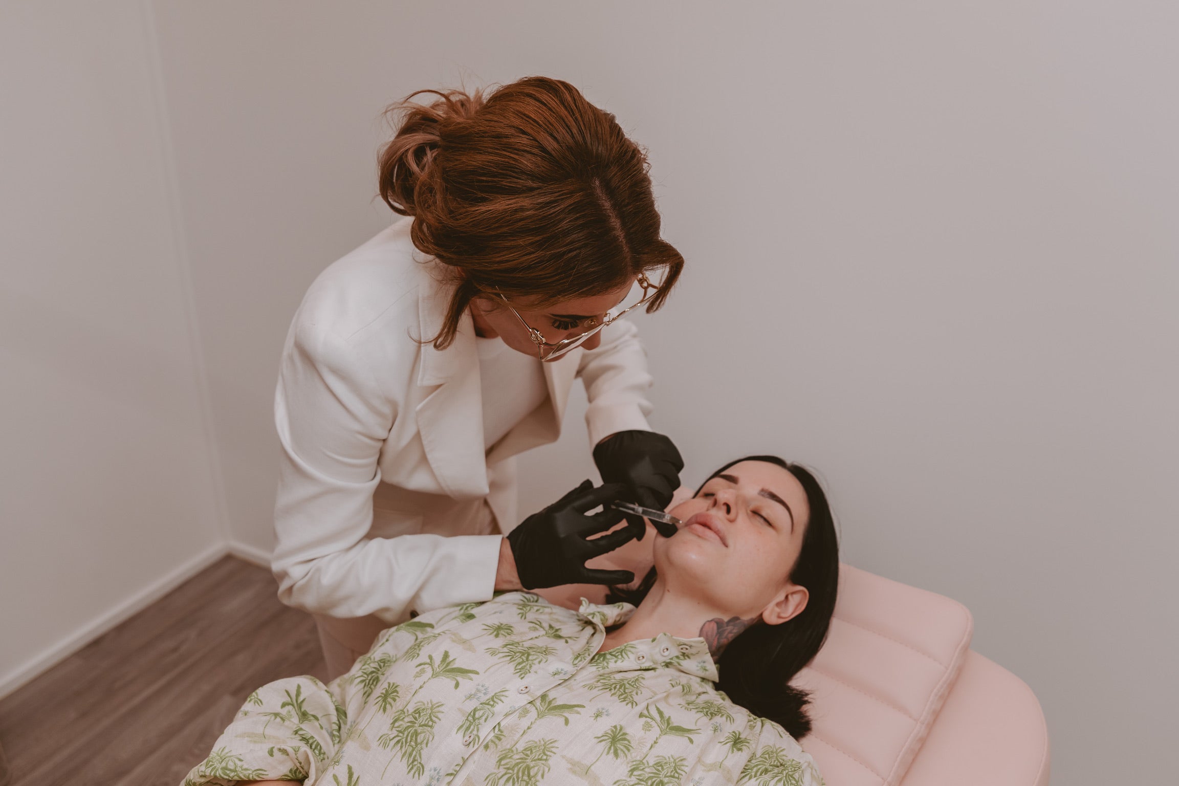 A model receiving lip filler treatment at Mel Hornery Cosmetics, showcasing the advanced services offered by top-rated skin clinics.