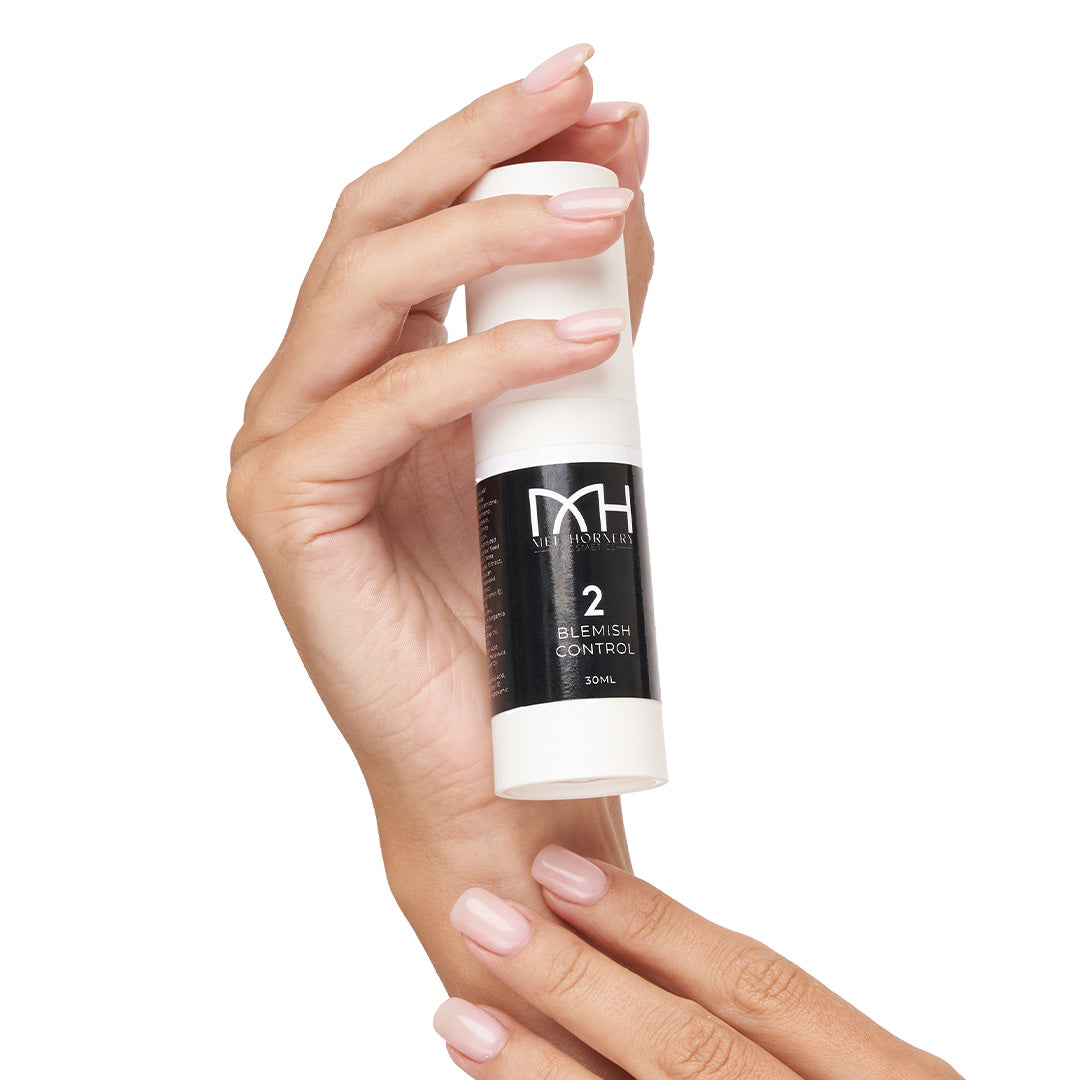 hands holding blemish control, a premium skincare product by Mel Hornery Cosmetics.