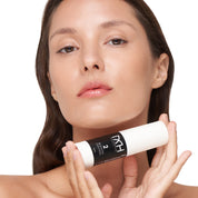 model with clear skin holding blemish control, a premium skincare product by Mel Hornery Cosmetics.