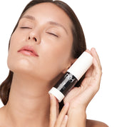 model with clear skin holding blemish control, a premium skincare product by Mel Hornery Cosmetics.