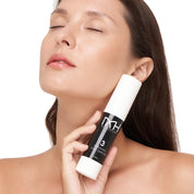 Model with clear skin holding Dynamic Day Serum, a premium skincare product by Mel Hornery Cosmetics.