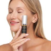 Model with clear skin holding Jimmys gold Serum, a premium skincare product by Mel Hornery Cosmetics.