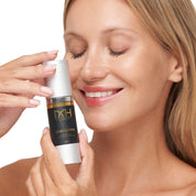 Model with clear skin holding John Dutton Serum, a premium skincare product by Mel Hornery Cosmetics.