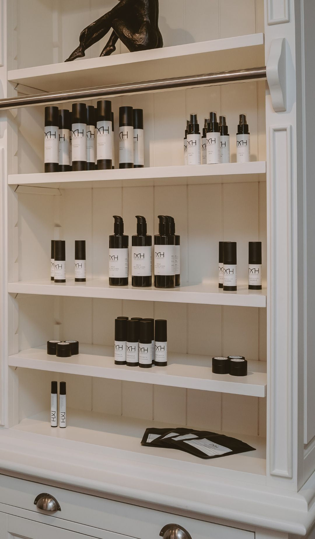 Mel Hornery Cosmetics wall of skincare products at their skin care clinic, featuring a diverse range of lotions, serums, and treatments arranged neatly on elegant shelves.